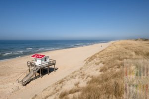 Sonniger Frühlingstag im April am fast menschenleeren Strand von Rantum/Sylt. Ein einziger Strandkorb steht bereits am Strand, die Hütte der Badeaufsicht steht auch schon auf dem hölzerlnen Podest